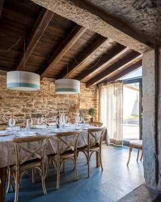 a dining room with a large table with chairs at Casa Peón de Pardaces in Santiago de Compostela