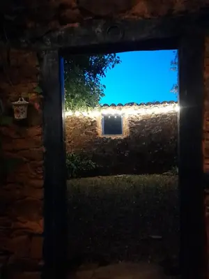 a view through a window in a brick wall at Arzipreste IV La Casita del Jardín in León