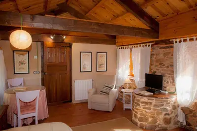 a living room with a desk and a computer in it at Arzipreste IV La Casita del Jardín in León