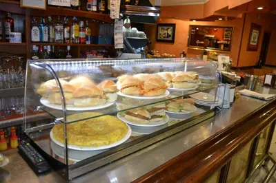 a buffet line with sandwiches and pies on plates at Hotel Restaurante Las Camelias in Jarrio