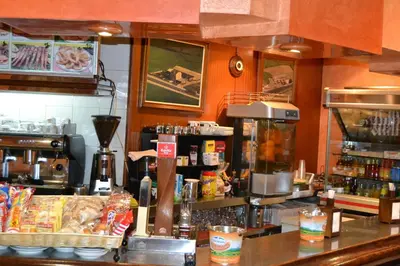 a kitchen with a counter with food and a counter sidx sidx at Hotel Restaurante Las Camelias in Jarrio