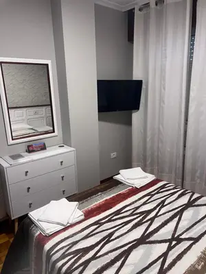 a bedroom with a bed with a mirror and a dresser at Hotel Celta Galaico in Viveiro