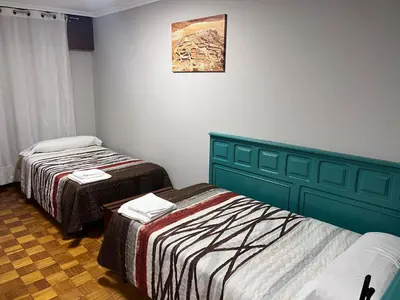 a room with two beds and a picture on the wall at Hotel Celta Galaico in Viveiro