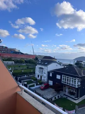 a view from a balcony of a house and the ocean at Hotel Celta Galaico in Viveiro