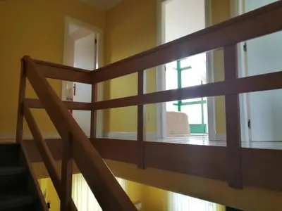 a wooden staircase in a room with a window at Urbanización Mar Cantábrico in Barreiros