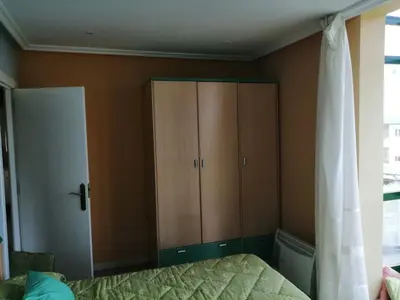 a bedroom with a cupboard and a bed at Urbanización Mar Cantábrico in Barreiros