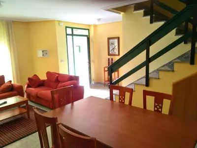 a living room with a table and a couch at Urbanización Mar Cantábrico in Barreiros