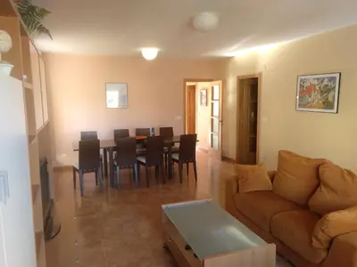 a living room with a couch and a table and chairs at Urbanización Mar Cantábrico in Barreiros