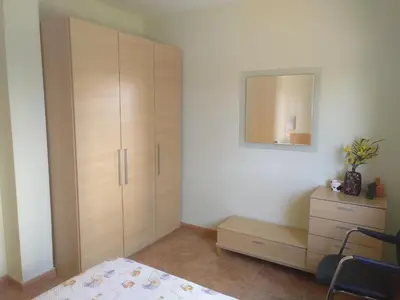 a bedroom with a dresser and a cabinet with a mirror at Urbanización Mar Cantábrico in Barreiros