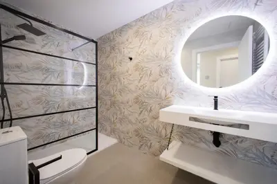 a bathroom with a sink and a mirror at Apartamentos O Devezo in Villalba