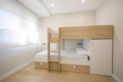 a small room with a bunk bed in it at Apartamentos O Devezo in Villalba
