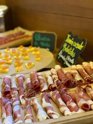a table topped with hot dogs and other foods at Pazo da Pena Manzaneda in Manzaneda