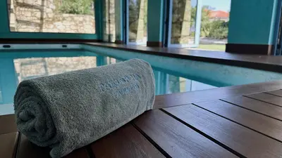 a towel sitting next to a swimming pool at Pazo da Pena Manzaneda in Manzaneda