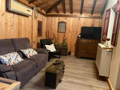a living room with a couch and a flat screen tv at casa teno in Parada de Achas