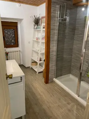 a bathroom with a shower and a glass door at casa teno in Parada de Achas