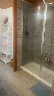 a shower with a glass door in a bathroom at casa teno in Parada de Achas