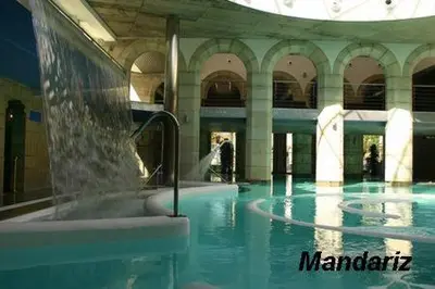 a swimming pool with a fountain in a building at casa teno in Parada de Achas