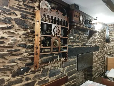 a wall in a restaurant with a stone wall at Casa Mameleiro e Casa Kintal in A Pontenova