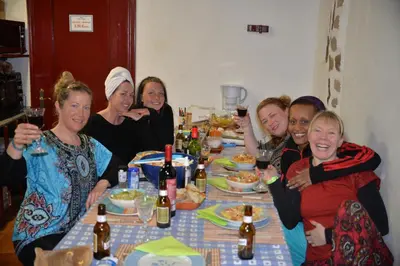 a group of people sitting around a dinner table at Albergue a Casina di Marcello in Palas de Rei