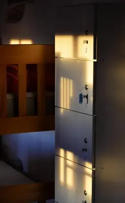 a white refrigerator in a room next to a bed at Albergue a Casina di Marcello in Palas de Rei