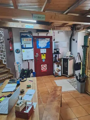 a room with a wooden table and a red door at Albergue a Casina di Marcello in Palas de Rei