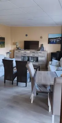 a living room with a table and a couch at El Rincón del Cúa in Vega de Espinareda
