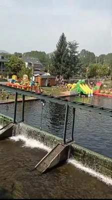 a water park with a water slide in the water at El Rincón del Cúa in Vega de Espinareda