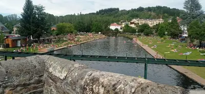 a group of people swimming in a river at El Rincón del Cúa in Vega de Espinareda