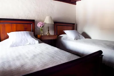 two beds sitting next to each other in a bedroom at Casona Puerto de Vega in Puerto de Vega