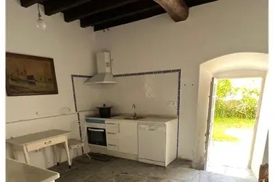 a kitchen with a sink and a stove top oven at Casona Puerto de Vega in Puerto de Vega