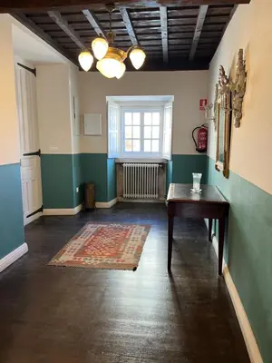 an empty room with a table and a window at Casona Puerto de Vega in Puerto de Vega