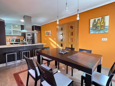 a kitchen and dining room with a wooden table and chairs at YourHouse Fontevella II in Ourense