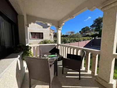 a patio with a table and chairs on a balcony at YourHouse Fontevella II in Ourense