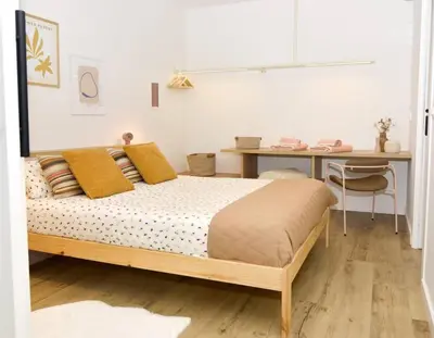 a bedroom with a bed and a table and a desk at Sienna Home Apartamento in Santiago de Compostela