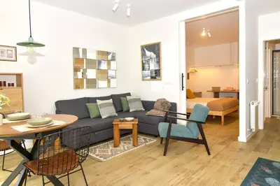 a living room with a couch and a table at Sienna Home Apartamento in Santiago de Compostela