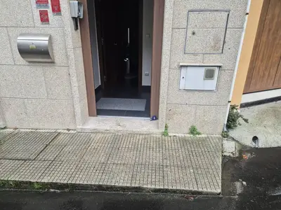 an entrance to a building with a door and a sidewalk at Sienna Home Apartamento in Santiago de Compostela