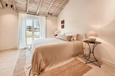 a bedroom with a large bed and a window at Casa Do Gaiteiro in Melide