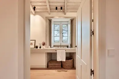 a bathroom with a sink and a window at Casa Do Gaiteiro in Melide