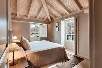 a bedroom with a large bed and a window at Casa Juanita in Melide