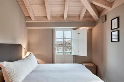 a bedroom with a bed and a table with a lamp at Casa Juanita in Melide