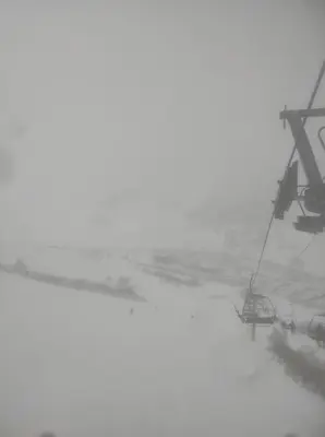 a ski lift in the snow next to a body of water at Cómo en casa Villablino in Villablino