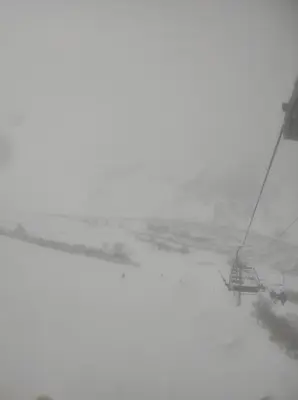 a ski lift in a snowstorm with a car on it at Cómo en casa Villablino in Villablino