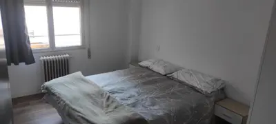 a bed in a small room with a window at Cómo en casa Villablino in Villablino