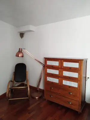 a room with a desk and a chair and a lamp at A Casa do outeiro in Ponteareas