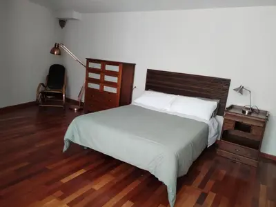 a bedroom with a bed and a desk and a chair at A Casa do outeiro in Ponteareas