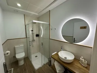 a bathroom with a toilet sink and a shower at Pensión María Castaña in Puebla del Brollón