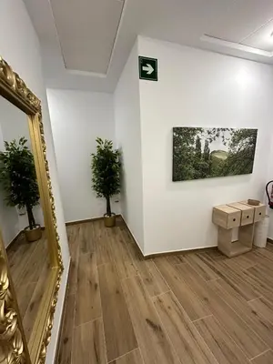 a room with a mirror and a painting on a wall at Pensión María Castaña in Puebla del Brollón