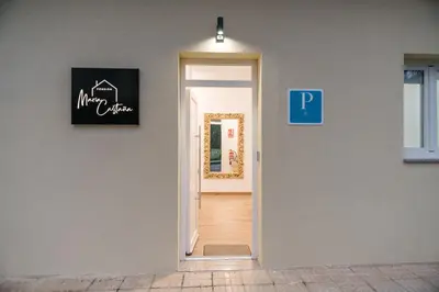 a door leading to a hallway with a sign on the wall at Pensión María Castaña in Puebla del Brollón