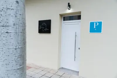 a white door with a sign on the side of a building at Pensión María Castaña in Puebla del Brollón
