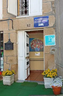 a entrance to a building with a door and flowers at Aqua Rooms Sarria in Sarria